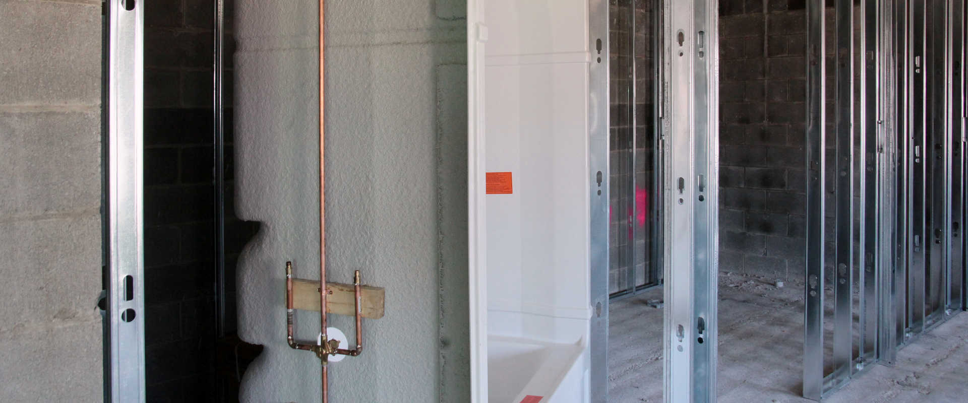 A large bath and plumbing is being installed at a multi-unit residential project or a retirement home by Barrett Mechanical Inc. in London.